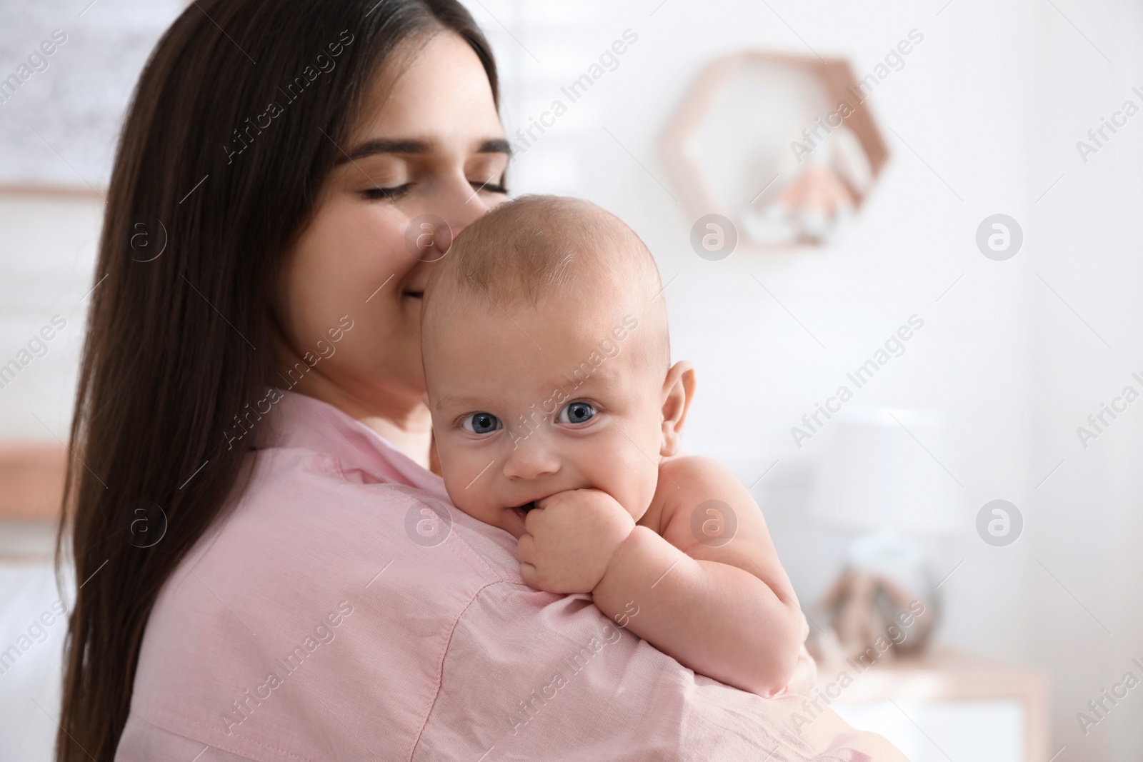 Photo of Mother with her cute baby at home