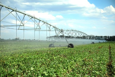 Photo of Center pivot irrigation system watering agricultural field 