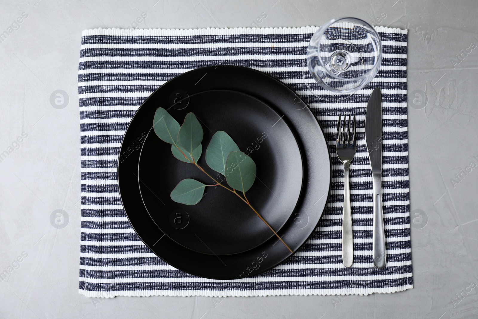 Photo of Elegant table setting on grey stone surface, top view