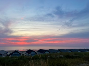 Many wooden houses on seacoast at sunset