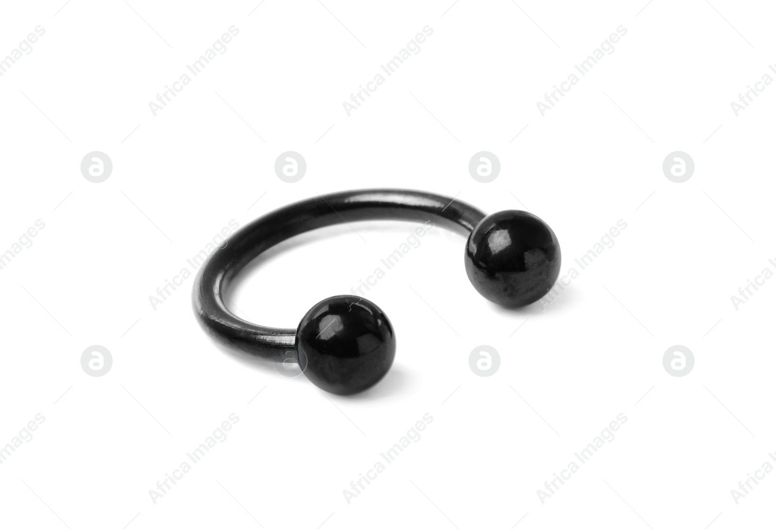 Photo of Piercing jewelry. Circular barbell isolated on white