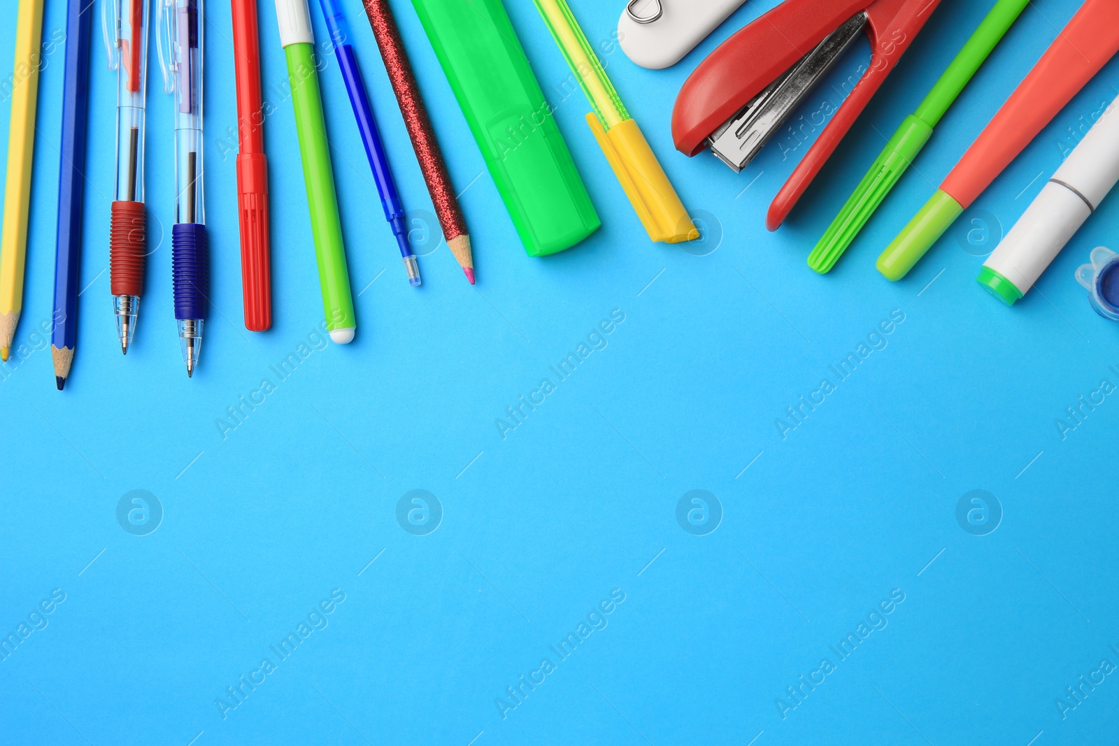 Photo of Flat lay composition with different school stationery on light blue background, space for text. Back to school