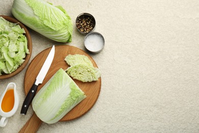 Photo of Fresh Chinese cabbages, oil and spices on light table, flat lay. Space for text