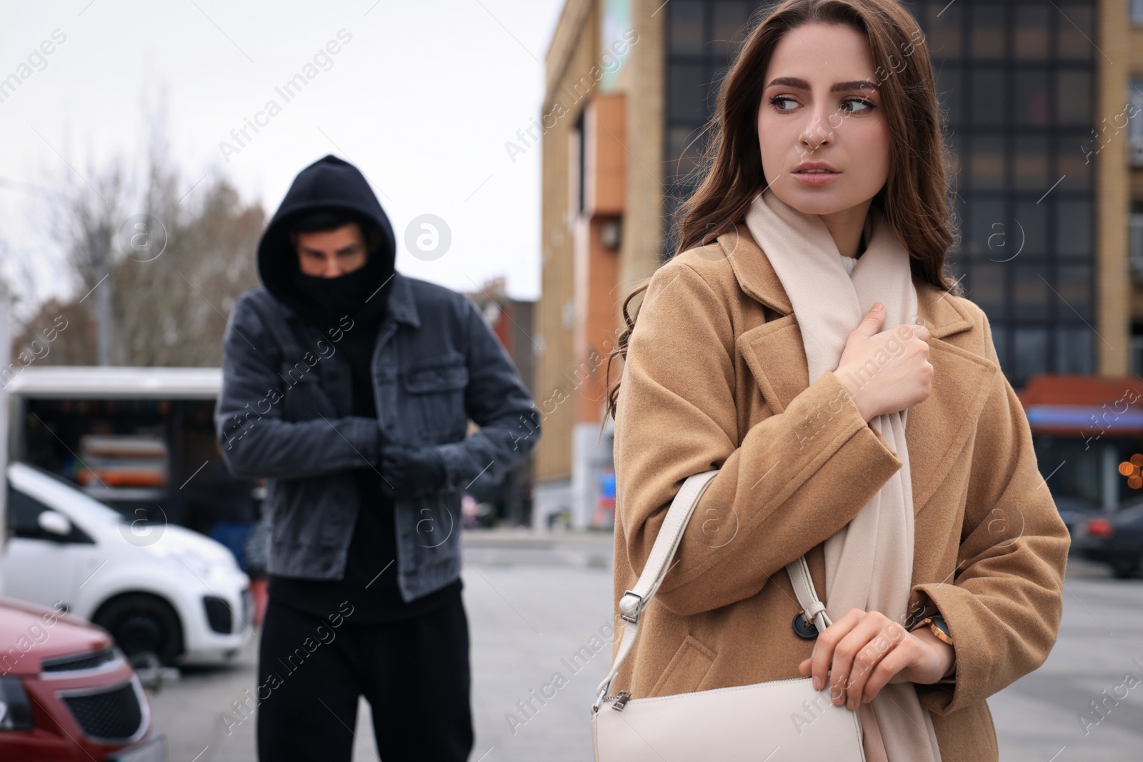 Photo of Man stalking young woman on city street
