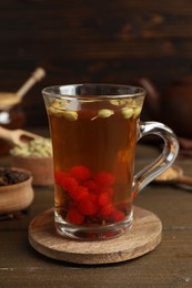 Photo of Tasty immunity boosting drink on wooden table