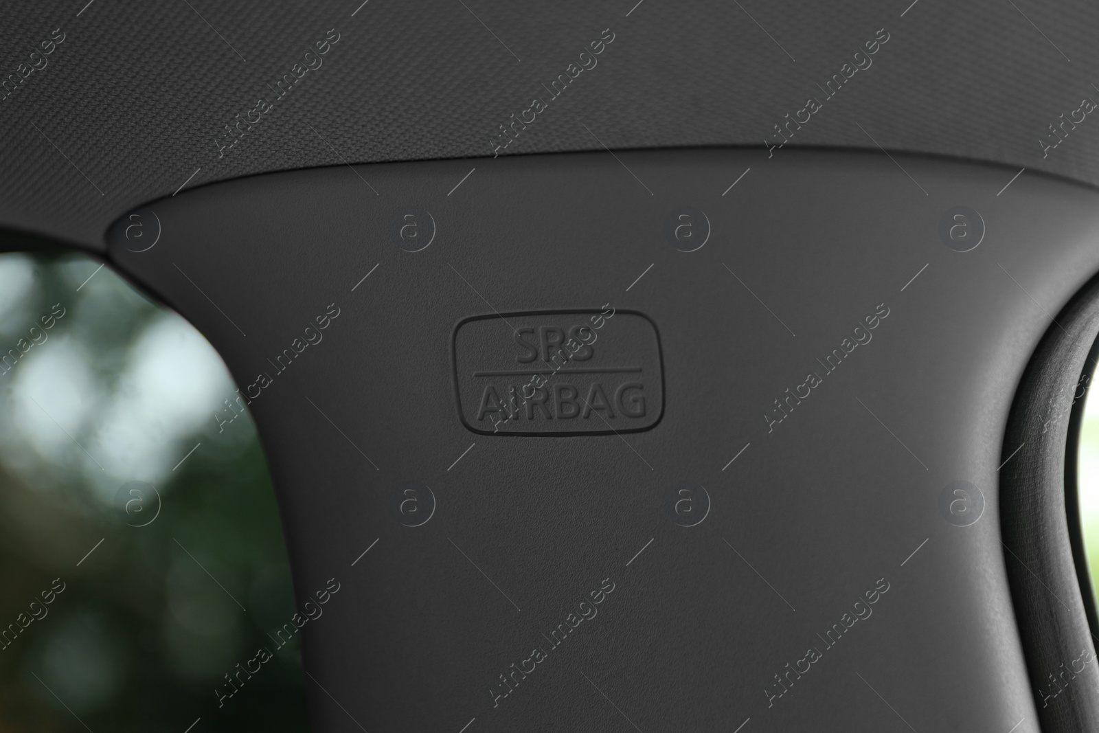 Photo of Safety airbag sign on center pillar panel in car, closeup