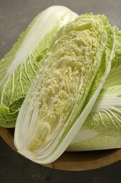 Photo of Fresh ripe Chinese cabbages in bowl on table, top view