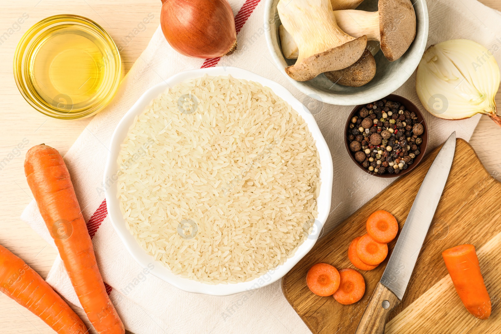 Photo of Flat lay composition with different ingredients on wooden table. Risotto recipe