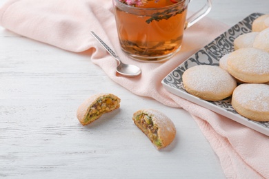 Traditional cookies for Islamic holidays and tea on wooden table. Eid Mubarak