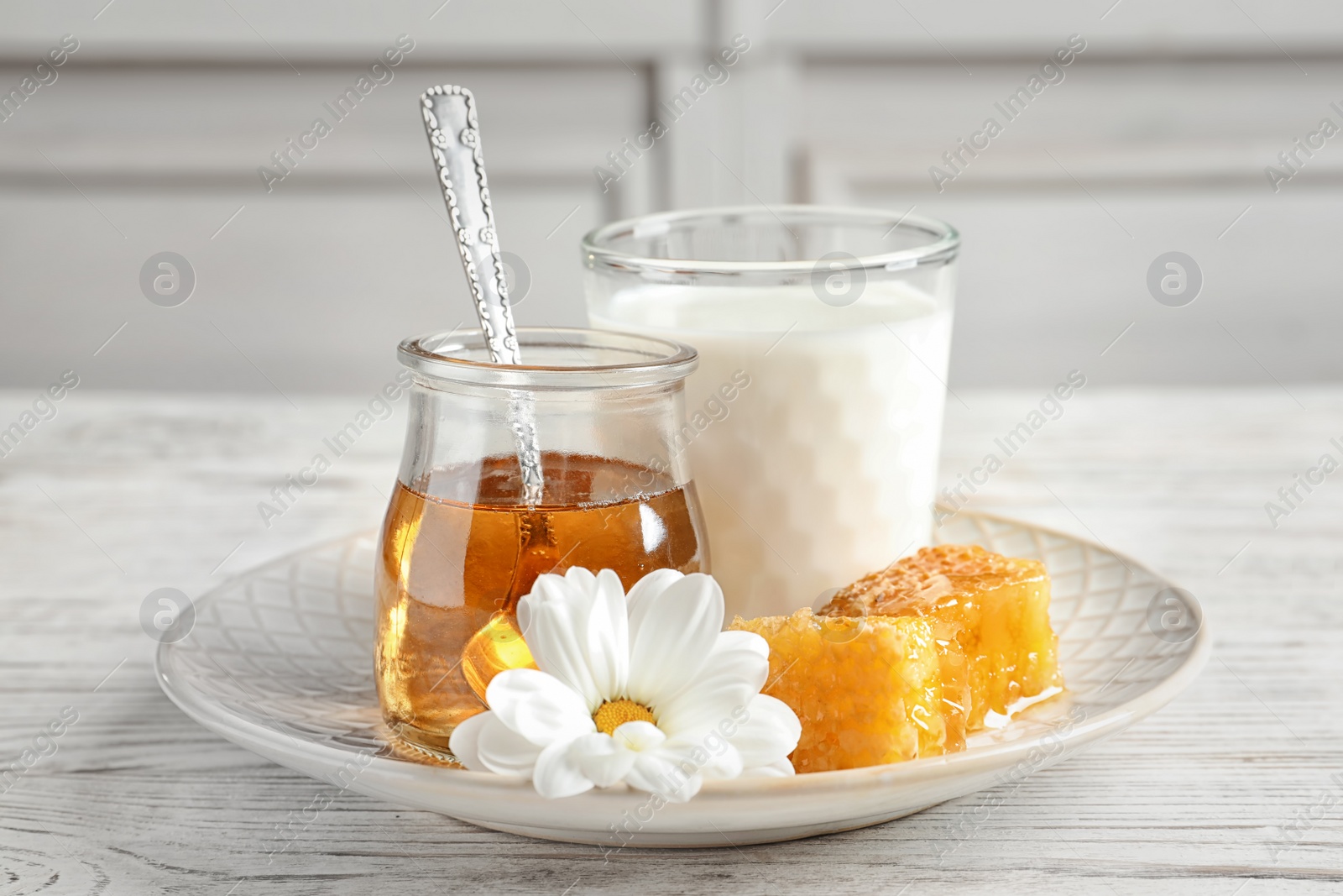 Photo of Beautiful composition with milk and honey on wooden table