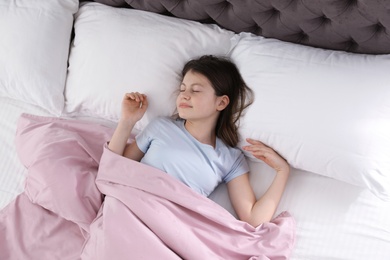 Photo of Beautiful little girl sleeping in bed, top view