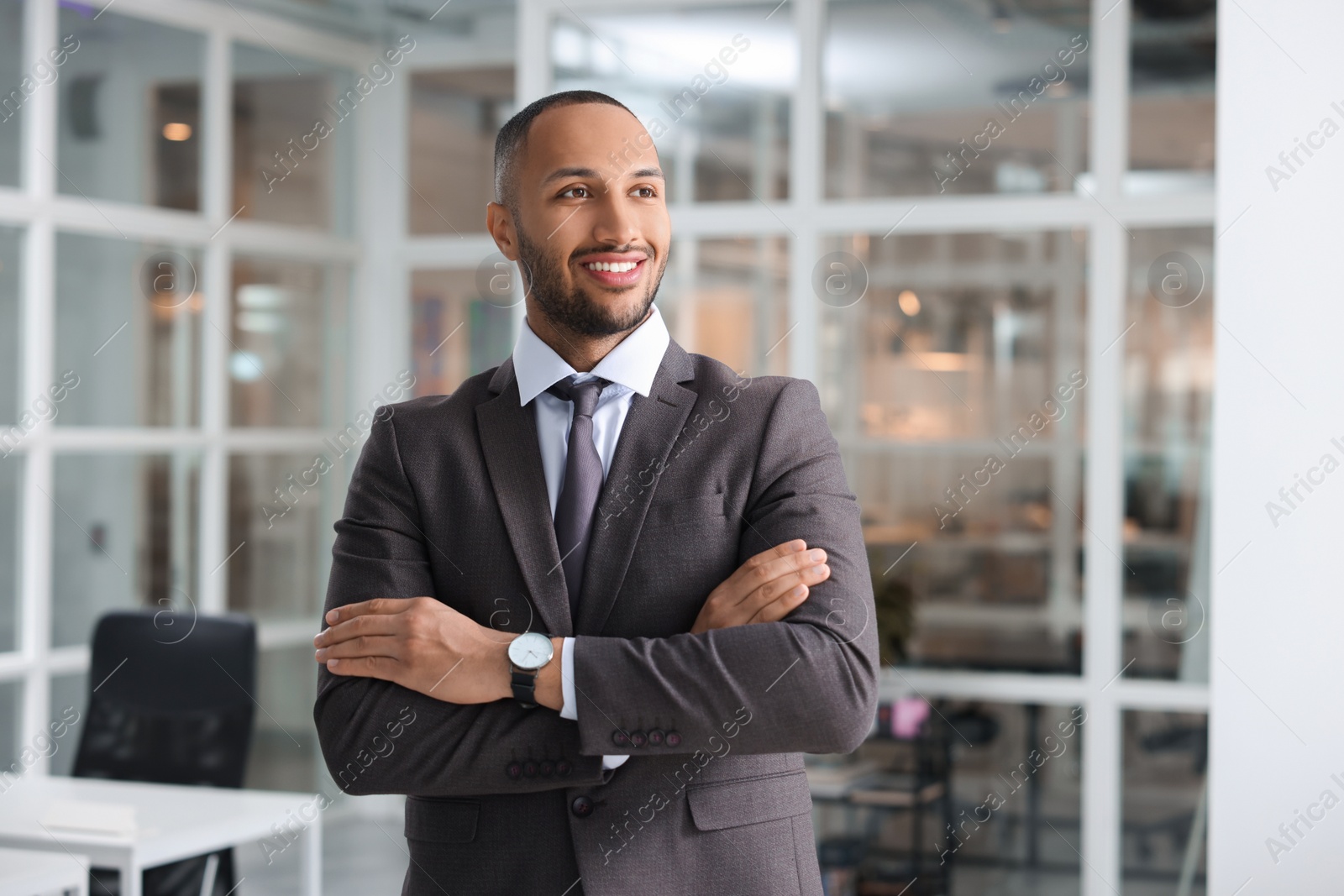 Photo of Happy man with crossed arms in office. Lawyer, businessman, accountant or manager