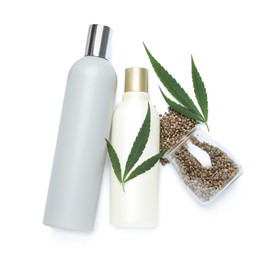 Photo of Set of hemp cosmetics with green leaves and seeds isolated on white, top view