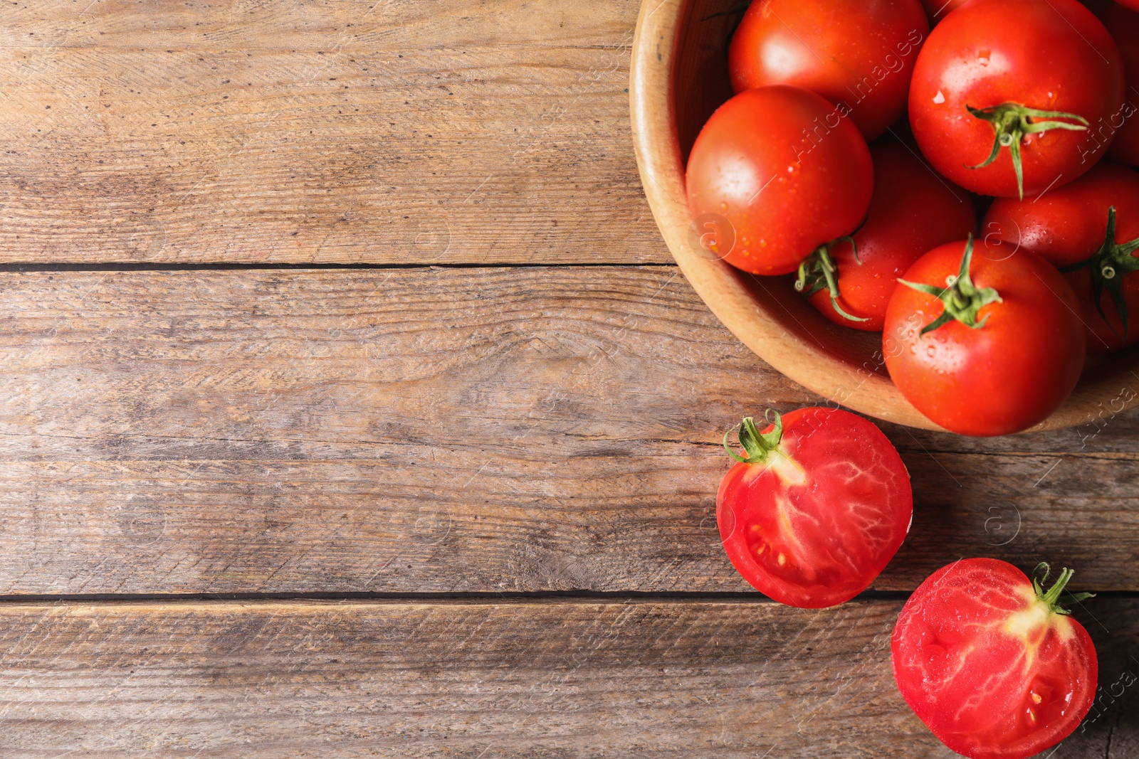 Photo of Fresh ripe tomatoes on wooden table, flat lay. Space for text