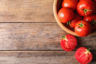 Fresh ripe tomatoes on wooden table, flat lay. Space for text