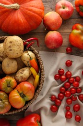 Different fresh ripe vegetables and fruits on wooden table, flat lay. Farmer produce