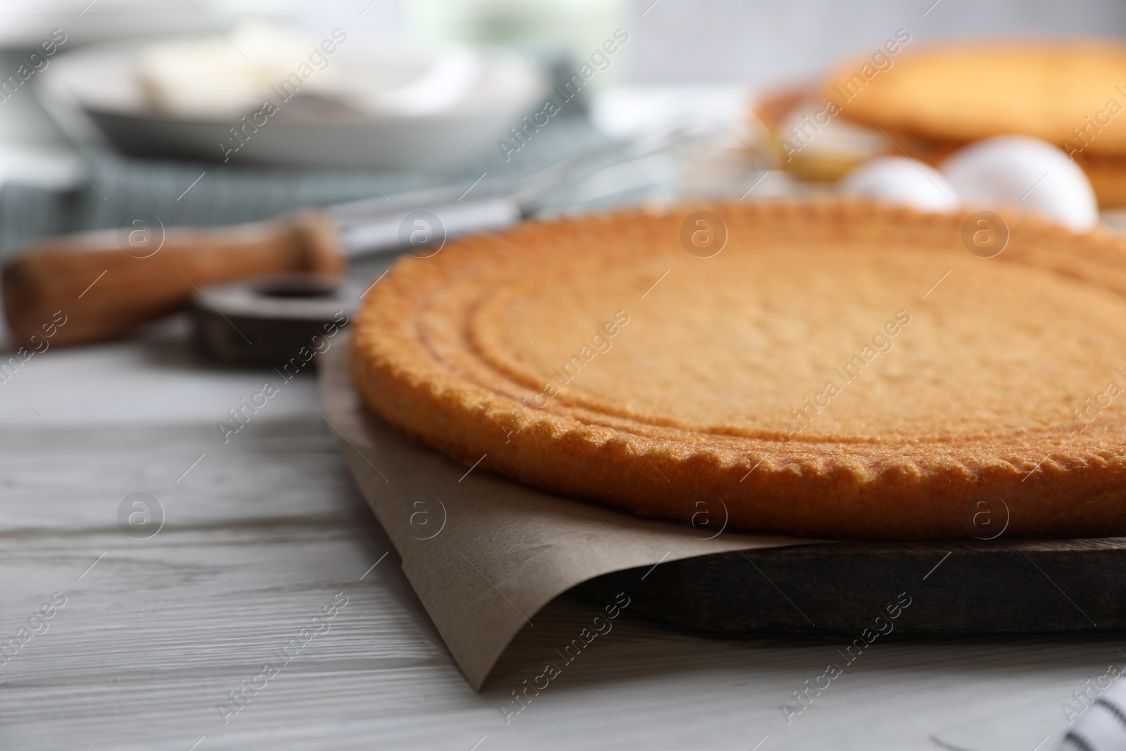 Photo of Delicious homemade sponge cake on white wooden table, closeup