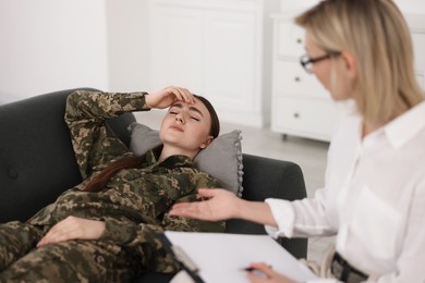 Psychotherapist working with military woman in office