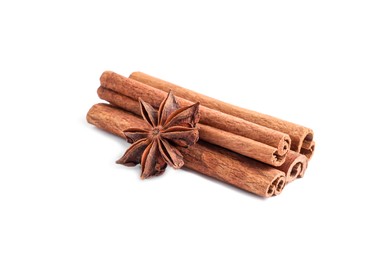 Photo of Aromatic cinnamon sticks and anise star isolated on white