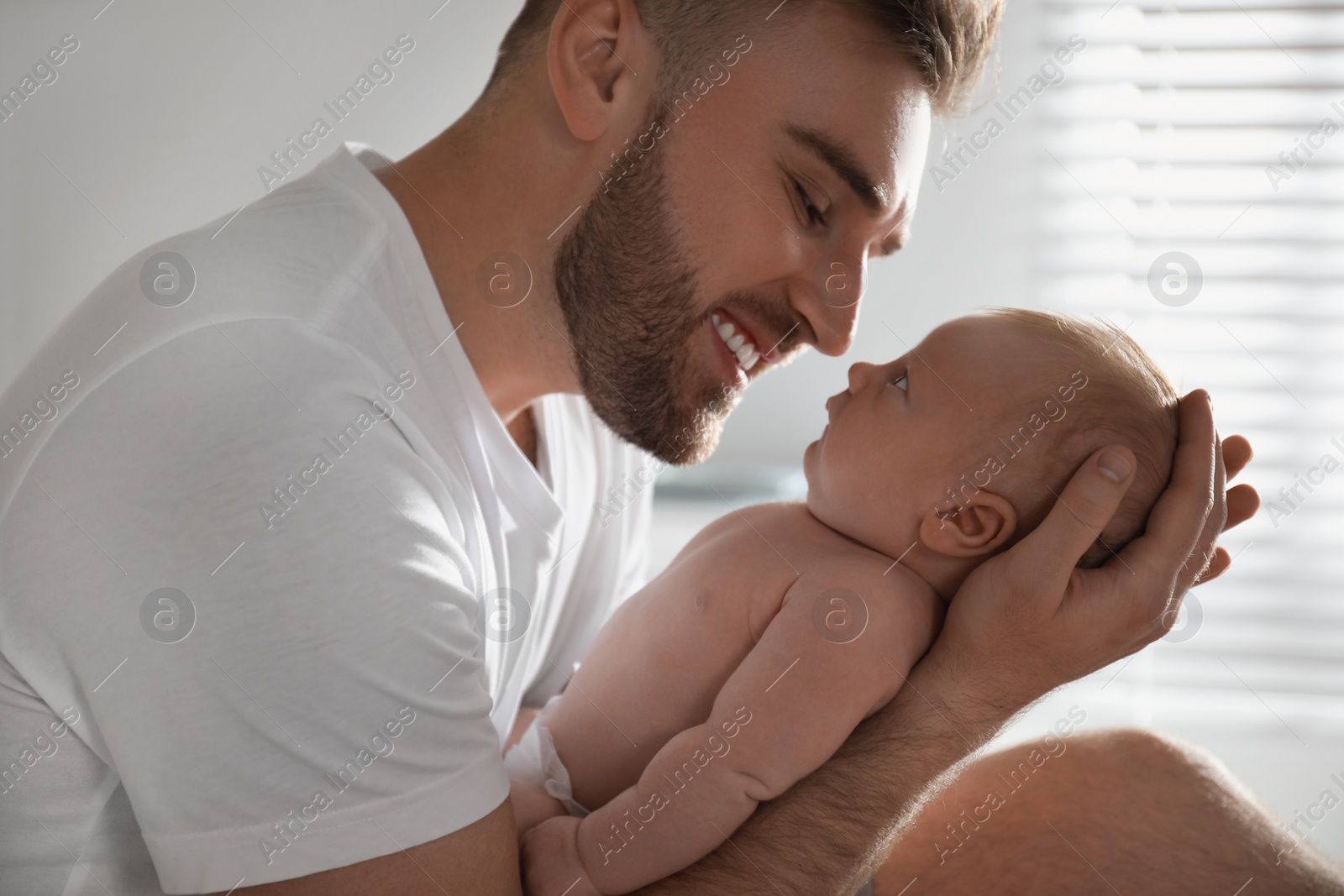 Photo of Father with his newborn son at home, closeup