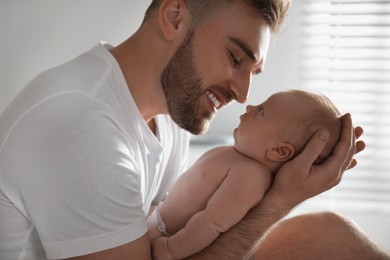 Photo of Father with his newborn son at home, closeup