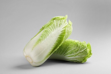 Photo of Fresh ripe Chinese cabbages on light grey background