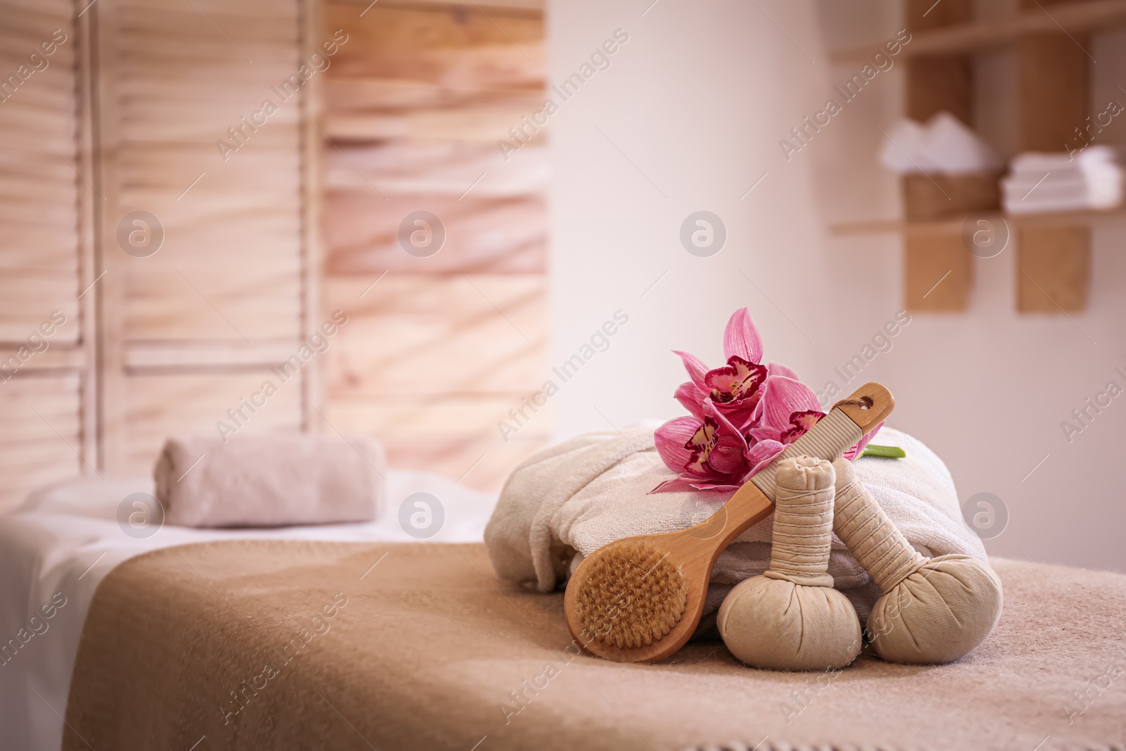 Photo of Beautiful spa accessories in massage room, space for text