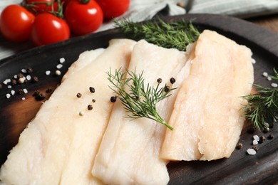 Photo of Raw cod fish, dill and spices on table, closeup