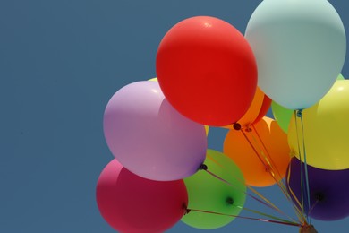 Photo of Bunch of colorful balloons against blue sky