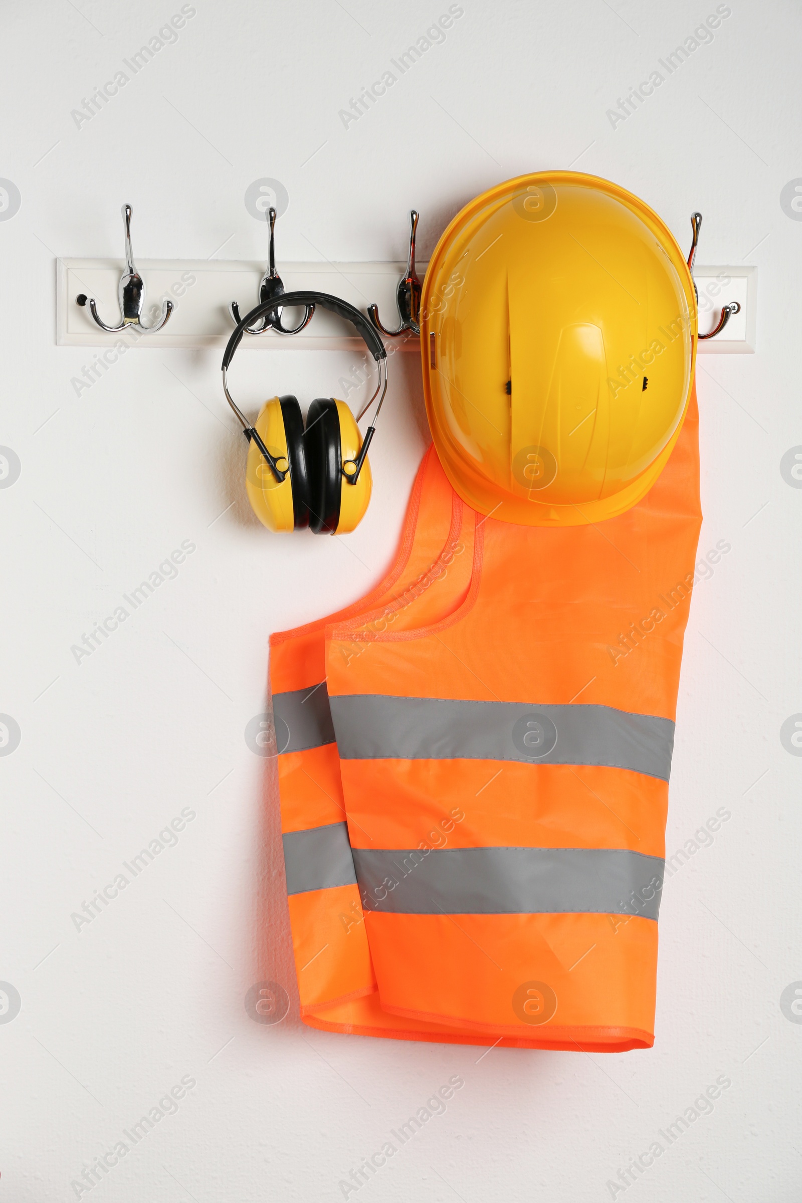 Photo of Different safety equipment hanging on white wall