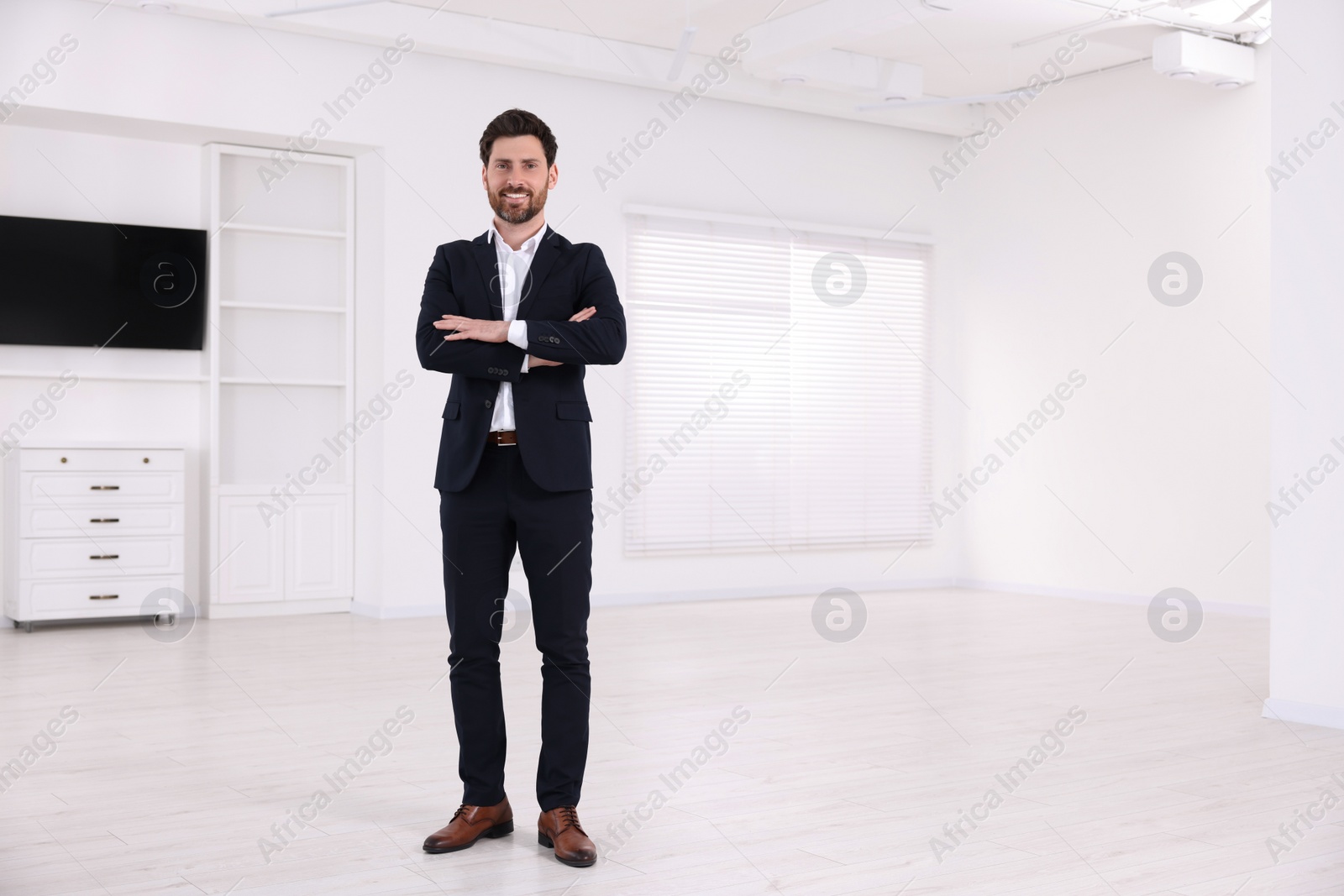 Photo of Happy real estate agent in new house