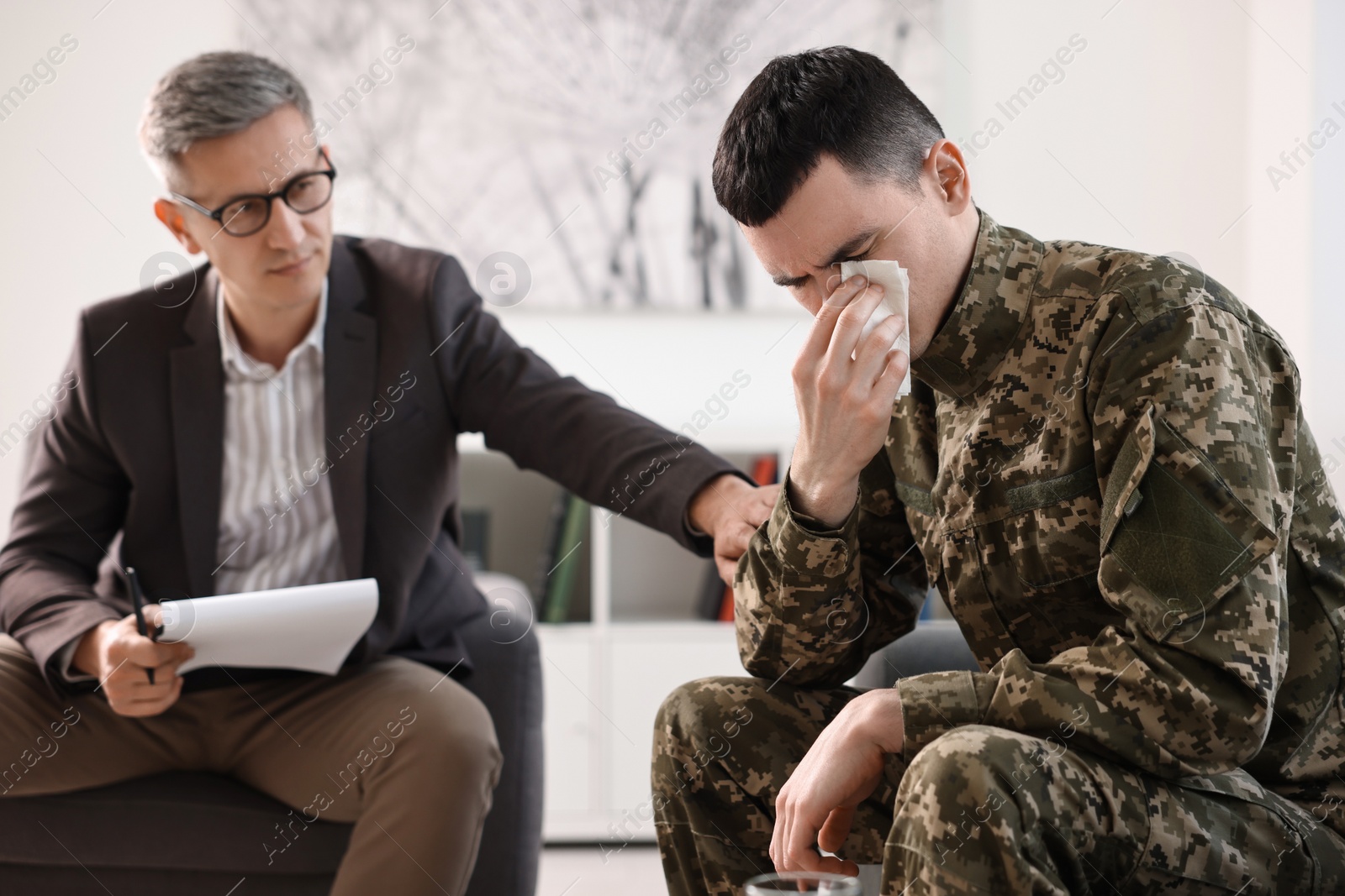 Photo of Professional psychotherapist working with military man in office