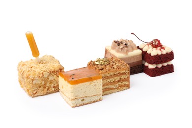 Pieces of different cakes on white background