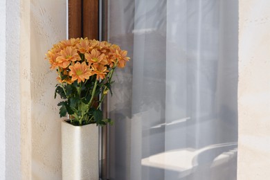 Photo of Bouquet of beautiful chrysanthemum flowers in vase near window outdoors