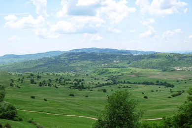 Photo of Picturesque view of beautiful green hills on sunny day
