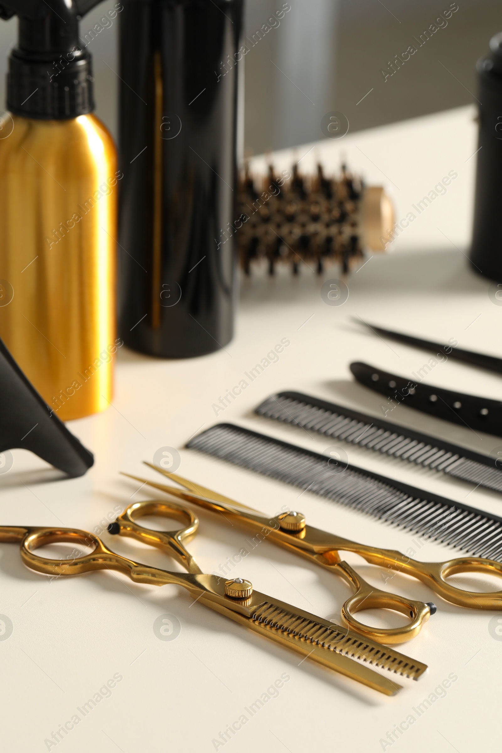 Photo of Hairdresser tools. Different scissors and combs on white table in salon