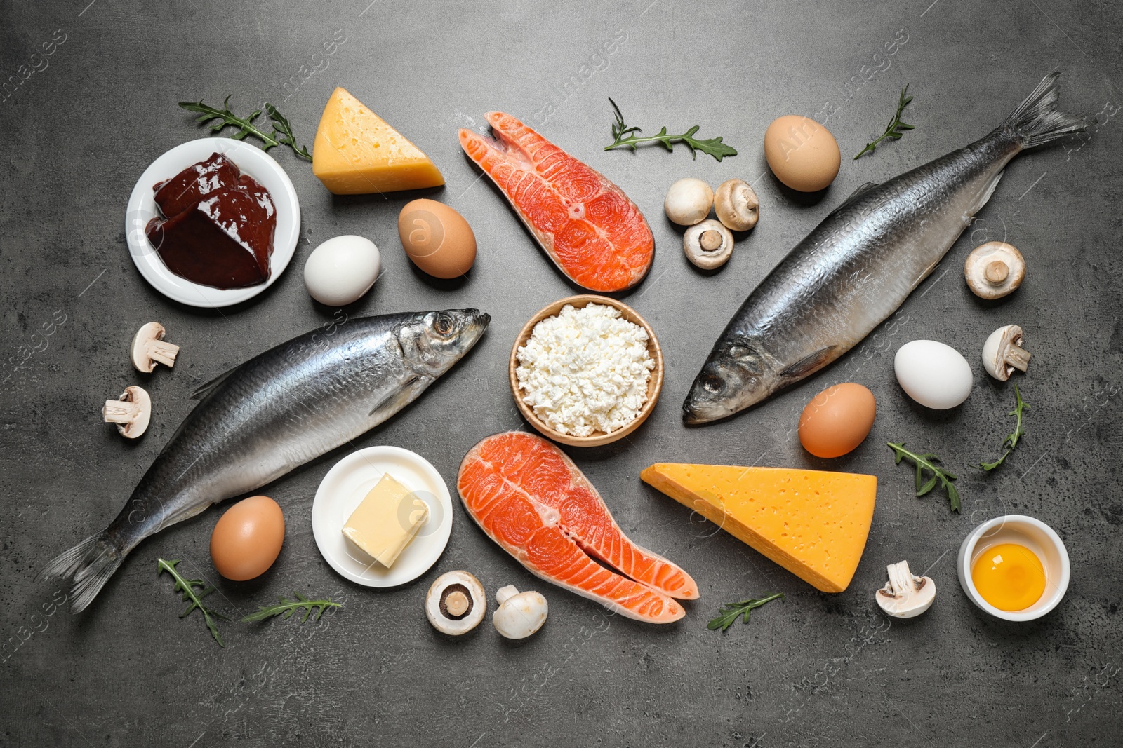 Photo of Fresh products rich in vitamin D on grey table, flat lay