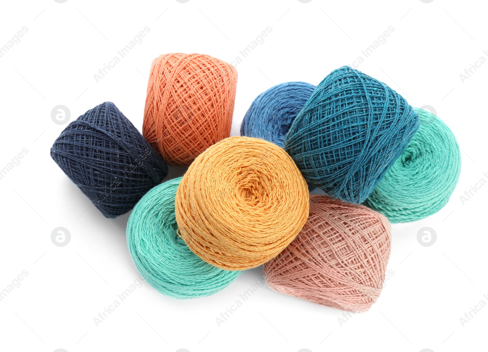 Photo of Clews of colorful knitting threads on white background, top view