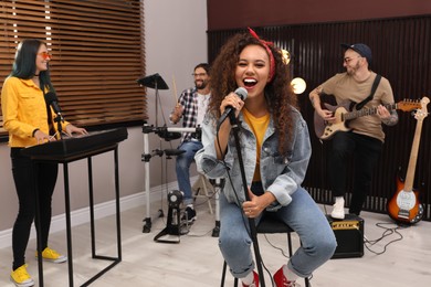 Music band performing in modern recording studio
