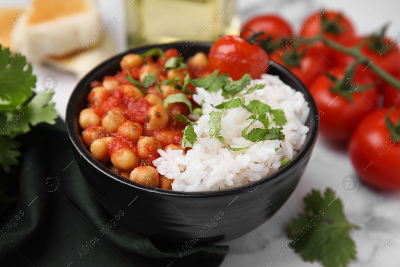 Photo of Delicious chickpea curry with rice in bowl on table, closeup