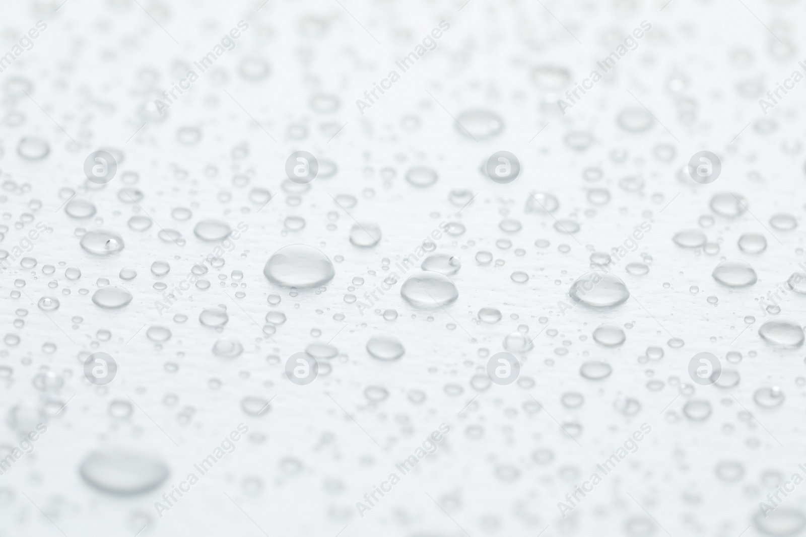 Photo of Water drops on white background, closeup view