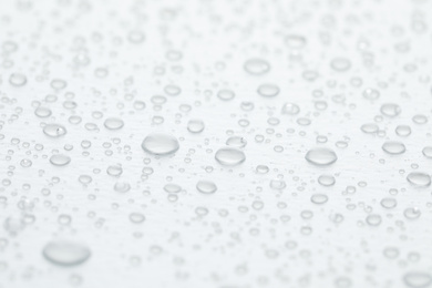 Water drops on white background, closeup view