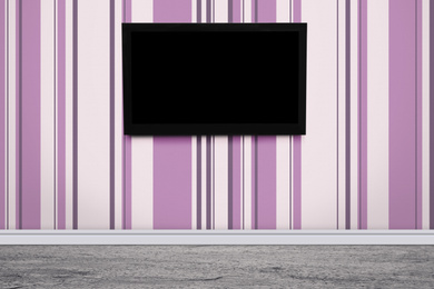 Image of Modern TV on color wall in room. Space for design