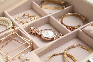 Photo of Jewelry box with stylish golden bijouterie, closeup view