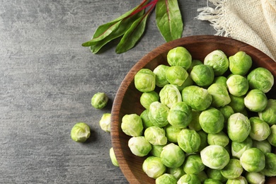 Photo of Flat lay composition with fresh Brussels sprouts and space for text on grey background