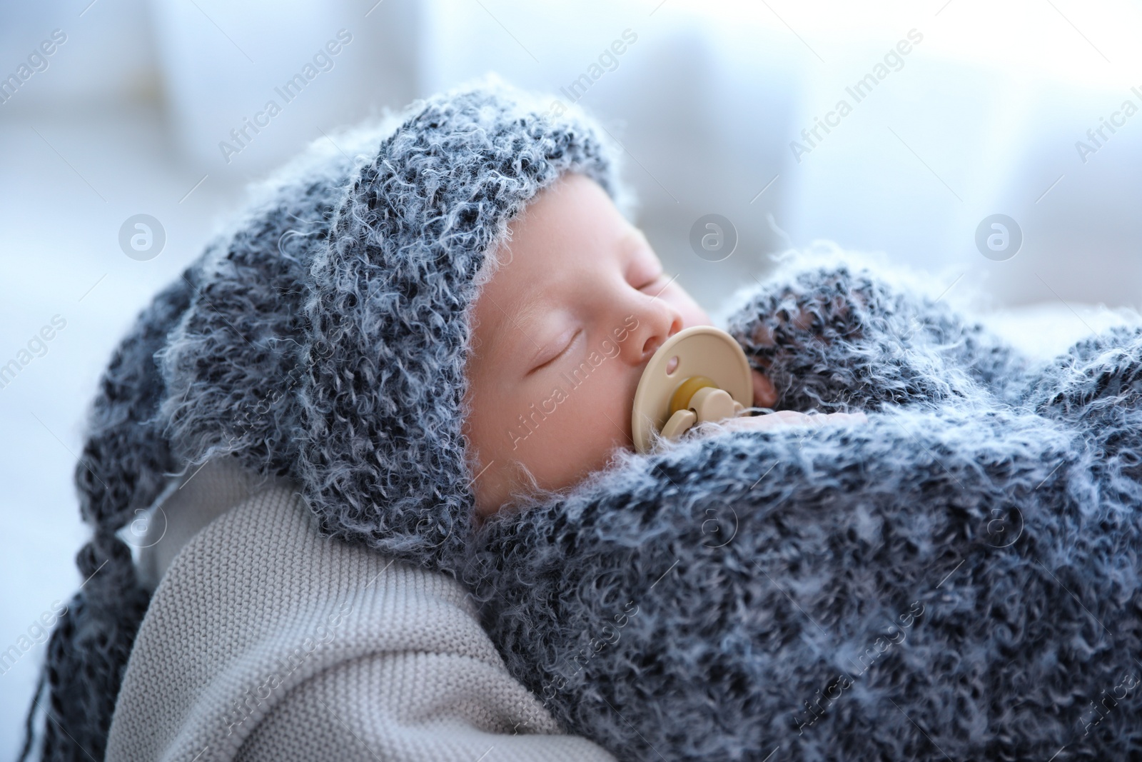 Photo of Cute newborn baby sleeping on plaid at home