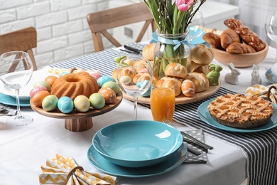 Photo of Festive Easter table setting with traditional meal at home