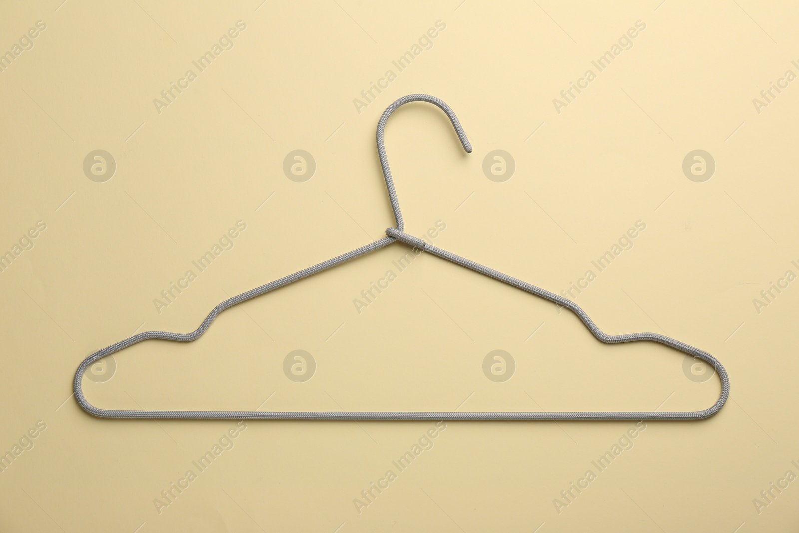 Photo of Hanger on pale yellow background, top view