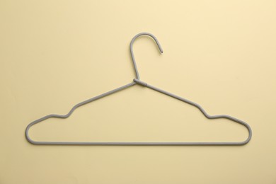 Photo of Hanger on pale yellow background, top view
