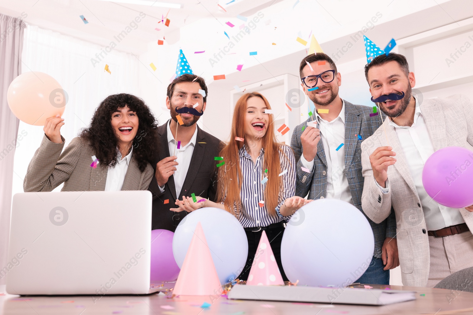 Photo of Coworkers having fun during office party indoors